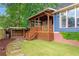 Backyard with green grass, stone pavers, a wooden deck, and shed at 694 Peeples Sw St, Atlanta, GA 30310