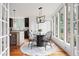 Charming breakfast nook with large windows, hardwood floors, and a stylish light fixture at 694 Peeples Sw St, Atlanta, GA 30310