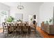 Spacious dining room featuring wood floors, a modern chandelier, and a sideboard at 694 Peeples Sw St, Atlanta, GA 30310