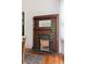 Close up of a dark wood fireplace with a decorative mantle and a brick surround at 694 Peeples Sw St, Atlanta, GA 30310