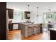 Kitchen with an island, granite countertops, stainless steel appliances, and hardwood floors at 694 Peeples Sw St, Atlanta, GA 30310