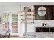 Kitchen showcasing granite countertops, custom shelving, stainless appliances, and a French door to a patio at 694 Peeples Sw St, Atlanta, GA 30310