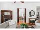 Elegant living room featuring hardwood floors, a cozy fireplace, and seamless transition to the dining area at 694 Peeples Sw St, Atlanta, GA 30310