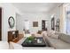 Spacious living room with hardwood floors and neutral decor, with large openings offering a view to other rooms at 694 Peeples Sw St, Atlanta, GA 30310