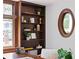 Custom wood shelving in a home office with an interesting oval window at 694 Peeples Sw St, Atlanta, GA 30310