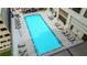Aerial view of a long, resort-style community swimming pool surrounded by lounge chairs and tables at 1280 W Peachtree Nw St # 4003, Atlanta, GA 30309