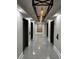 Hallway featuring modern lighting fixtures and stylish tile flooring at 1280 W Peachtree Nw St # 4003, Atlanta, GA 30309