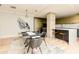 Contemporary dining area adjacent to a modern kitchen with marble countertops and stainless appliances at 1280 W Peachtree Nw St # 4003, Atlanta, GA 30309