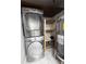 Efficient laundry area with stackable washer/dryer and shelving for storage at 1280 W Peachtree Nw St # 4003, Atlanta, GA 30309