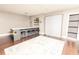 Open-concept area featuring hardwood floors, a modern bar, and a Murphy bed at 1280 W Peachtree Nw St # 4003, Atlanta, GA 30309