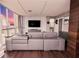 Modern living room with gray sectional sofa and floor-to-ceiling windows overlooking city at 1280 W Peachtree Nw St # 4003, Atlanta, GA 30309
