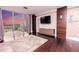 Spacious living room featuring dark wood floors, plush rug, and floor to ceiling windows with city views at 1280 W Peachtree Nw St # 4003, Atlanta, GA 30309