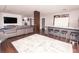 Open-concept living room featuring hardwood floors, a modern couch, and a kitchen bar at 1280 W Peachtree Nw St # 4003, Atlanta, GA 30309
