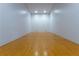 Spacious racquetball court with hardwood floors and white walls, perfect for recreational games and fitness at 1280 W Peachtree Nw St # 4003, Atlanta, GA 30309