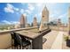 Rooftop deck with outdoor dining area offering stunning city skyline views at 1280 W Peachtree Nw St # 4003, Atlanta, GA 30309