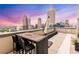 Outdoor rooftop space, featuring a dining table and expansive city views at 1280 W Peachtree Nw St # 4003, Atlanta, GA 30309