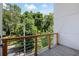 Spacious balcony with wood and metal railing, offering picturesque views of surrounding trees and neighborhood at 1463 Macklone Ne St, Atlanta, GA 30307