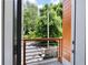 Balcony with wood and metal railing and views of surrounding greenery at 1463 Macklone Ne St, Atlanta, GA 30307