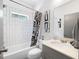 Bathroom with tub-shower combo, tile surround, and single sink vanity at 1463 Macklone Ne St, Atlanta, GA 30307