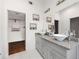 Bathroom featuring dual sinks with granite counters and a walk-in closet with shelving at 1463 Macklone Ne St, Atlanta, GA 30307