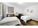 Bright bedroom featuring two twin beds with white comforters and hardwood floors at 1463 Macklone Ne St, Atlanta, GA 30307