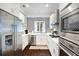Modern kitchen with stainless steel appliances, white cabinets, and mosaic backsplash, offering a sleek and functional design at 1463 Macklone Ne St, Atlanta, GA 30307