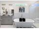 Bright main bathroom with soaking tub, walk-in shower, dual sinks, granite counters, and tile accents at 1463 Macklone Ne St, Atlanta, GA 30307