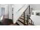 Staircase with wood and metal railing plus hardwood steps, with the front door visible at the bottom at 1463 Macklone Ne St, Atlanta, GA 30307
