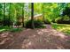 Backyard view showing a serene, wooded area with the house partially visible at 1781 Point Pleasant Se, Smyrna, GA 30080