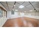 Large basement area with laminate flooring, shelving, and recessed lights at 1781 Point Pleasant Se, Smyrna, GA 30080