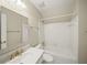 A bright bathroom with a tub, and a vanity with gold colored fixtures at 1781 Point Pleasant Se, Smyrna, GA 30080