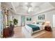 Bright bedroom featuring a trey ceiling, hardwood floors, and a large window with floral curtains at 1781 Point Pleasant Se, Smyrna, GA 30080