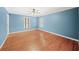 Light-filled bedroom with a ceiling fan, hardwood floors, white trim, and painted blue walls at 1781 Point Pleasant Se, Smyrna, GA 30080