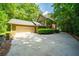 Exterior view showcasing the garage and driveway in a green environment at 1781 Point Pleasant Se, Smyrna, GA 30080