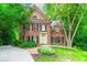 Charming brick home with manicured lawn and lush landscaping and beautiful architectural details at 1781 Point Pleasant Se, Smyrna, GA 30080