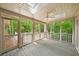 Enclosed patio with ceiling fan and view of the green surroundings at 1781 Point Pleasant Se, Smyrna, GA 30080