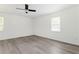 Bright bedroom featuring new floors, fresh white paint, and a modern ceiling fan at 2879 Harlan Dr, Atlanta, GA 30344