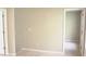 A bright room with carpeted floors, neutral walls, and a view into another room at 623 Shadowmoore Dr, Riverdale, GA 30274