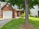 Charming brick home with a well-manicured lawn and attached garage at 623 Shadowmoore Dr, Riverdale, GA 30274