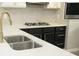 Modern kitchen features a stainless steel sink, a gas stove, and lovely stone countertops at 623 Shadowmoore Dr, Riverdale, GA 30274