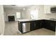 Open-concept kitchen featuring stainless steel appliances and island with sleek countertops at 623 Shadowmoore Dr, Riverdale, GA 30274