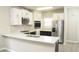 Modern kitchen featuring stainless steel appliances and island with sleek white countertops at 623 Shadowmoore Dr, Riverdale, GA 30274