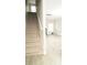 A brightly lit living room featuring stairs, hardwood floors, and neutral walls at 623 Shadowmoore Dr, Riverdale, GA 30274