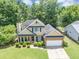 Beautiful home with landscaped yard, mature trees, and an attached two car garage at 10535 Willow Meadow Cir, Alpharetta, GA 30022