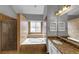 Bright main bathroom with tiled shower, separate soaking tub, and granite topped vanity with sink at 10535 Willow Meadow Cir, Alpharetta, GA 30022