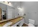 Bathroom featuring a double vanity with granite countertop and large mirror at 10535 Willow Meadow Cir, Alpharetta, GA 30022