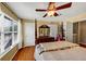 Bedroom with hardwood flooring, ceiling fan, and natural light from large window at 10535 Willow Meadow Cir, Alpharetta, GA 30022