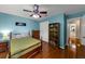 Well-lit bedroom with hardwood floors, ceiling fan, and closet, ideal for or guests at 10535 Willow Meadow Cir, Alpharetta, GA 30022