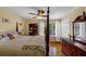 Bright bedroom features hardwood flooring, ceiling fan, and natural light from a large window at 10535 Willow Meadow Cir, Alpharetta, GA 30022