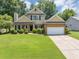 Charming two-story home with brick accents, lush lawn, and a two car garage at 10535 Willow Meadow Cir, Alpharetta, GA 30022